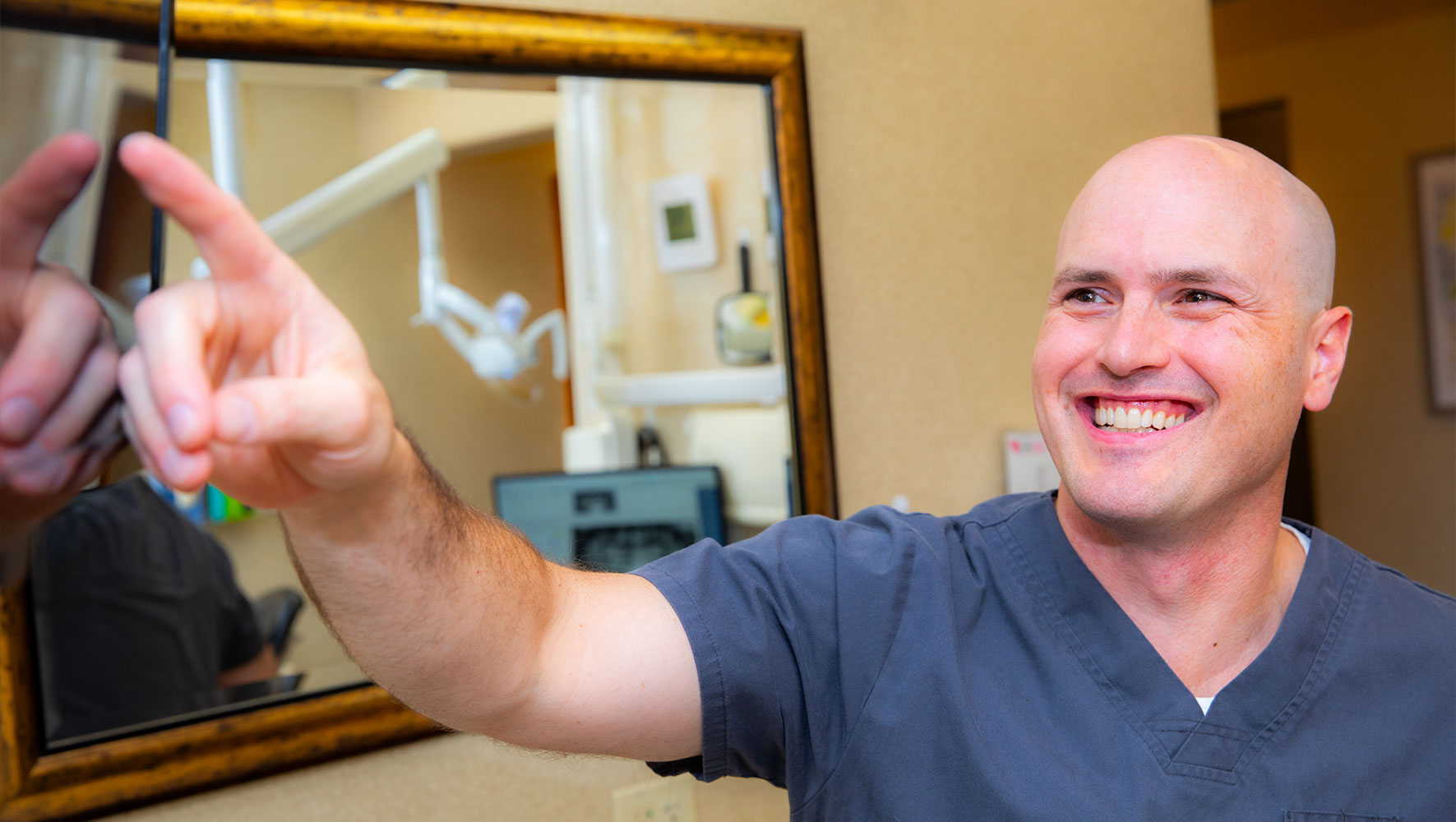 Doctor showcasing dental information for patient within the dental practice